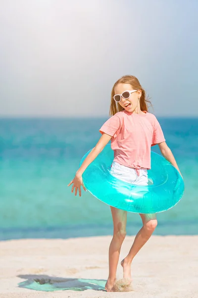 सुंदर छोटी लड़की छुट्टी के दौरान उष्णकटिबंधीय समुद्र तट पर मज़ा है — स्टॉक फ़ोटो, इमेज