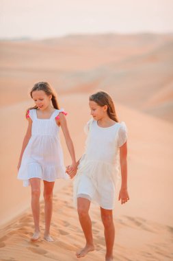 Birleşik Arap Emirlikleri 'nde Rub al-Khali çölündeki kum tepeleri arasında yaşayan kızlar