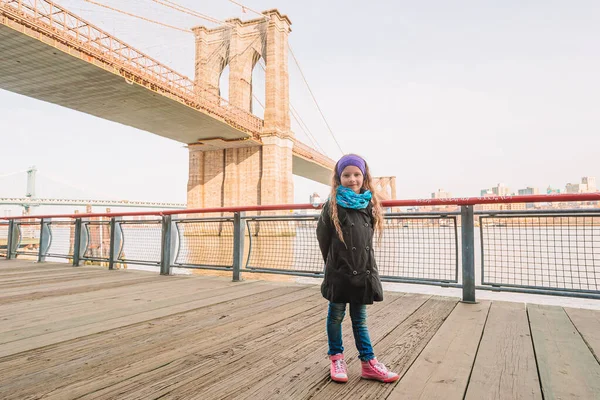 愛らしい女の子座っていますでブルックリン橋でニューヨーク — ストック写真