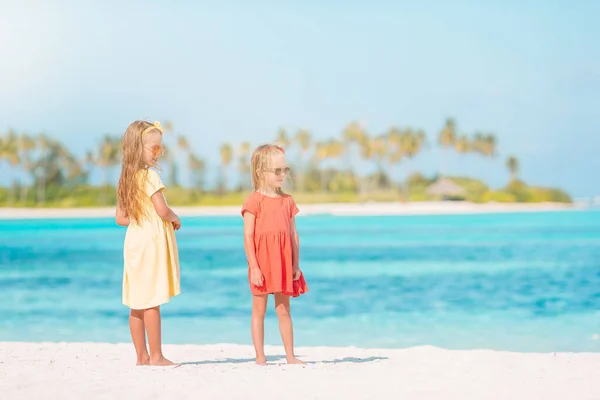Roztomilé holčičky mají spoustu zábavy na pláži. — Stock fotografie