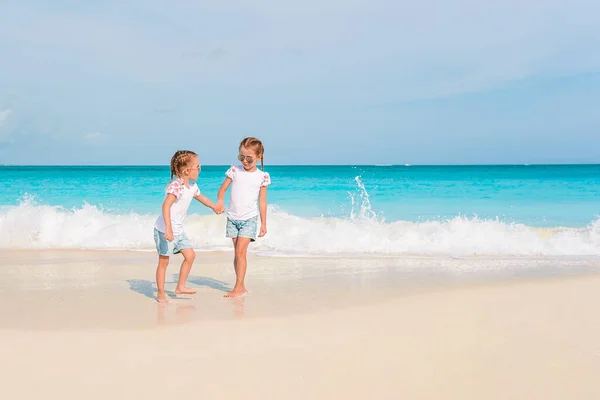 Schattige kleine meisjes hebben veel plezier op het strand. — Stockfoto