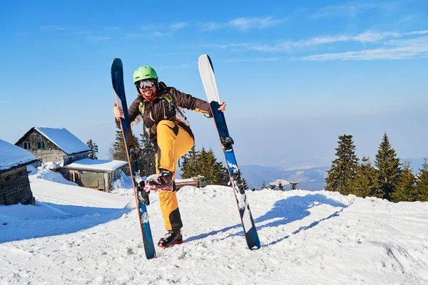 Funny skier mimics putting his skis on wrong, vertically. Location: Poiana Brasov ski resort, Romania.