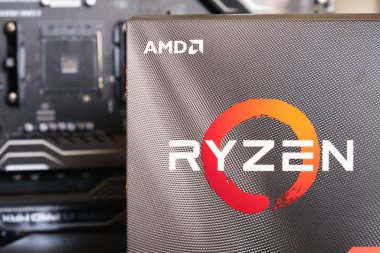 AMD Ryzen CPU box in front of a motherboard. clipart
