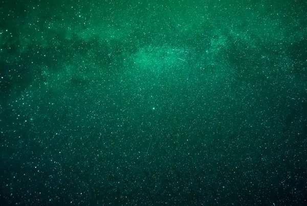 background of abstract galaxies with stars and planets with green galaxy motif of night light universe