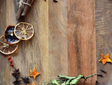 Space of a wooden table framed by spices. View from above. Photo image.
