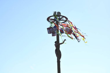 A man climbs up the Pancake week. Celebration of Russian carnival. Photo image.