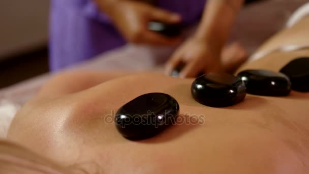 Close up Thai massage of woman with hot stones — Stock Video