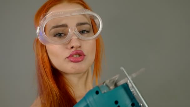 Menina sexy com serra elétrica em mãos de perto — Vídeo de Stock