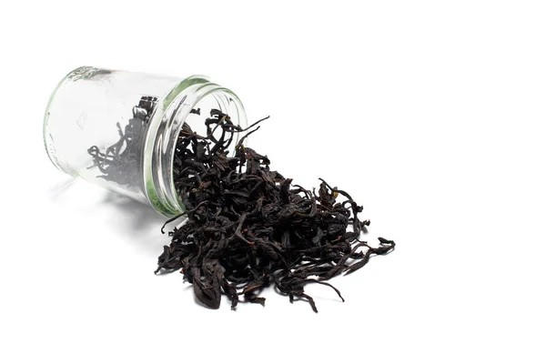 Dried, fermented willow-herb, poured from a glass jar. Isolated on a white background. — Φωτογραφία Αρχείου