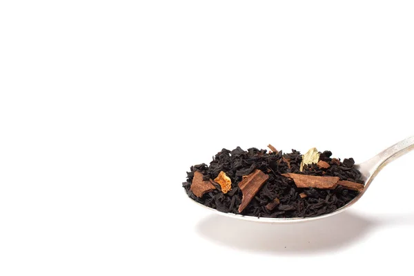 Dry leaves of black fruit tea with orange and cinnamon on a spoon. Isolate on a white background. — Stock Photo, Image
