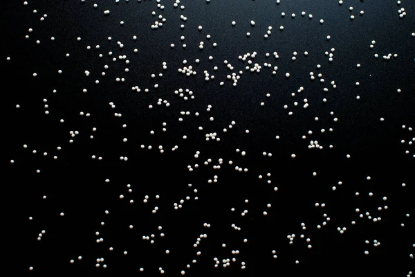 Siyah Arka Planda Beyaz Şekerleme Topları Şeklinde Serpiştirilir — Stok fotoğraf