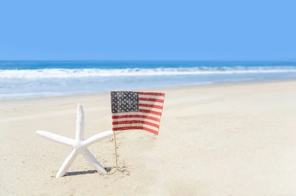 Patriotic USA background with starfish on the sandy beach