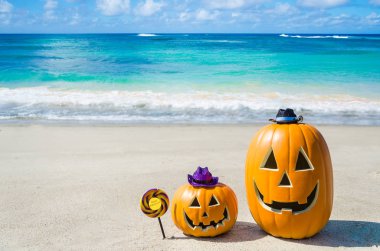 Halloween pumpkin background on the beach clipart