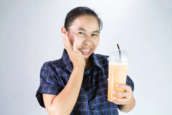 Mulher jovem asiática tocando bochecha com a mão porque ela dente sensibilidade e dor de dente de beber água fria. Conceito de atenção odontológica e saúde . — Fotografia de Stock