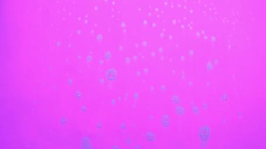 Pembe arka planda akan sabundan köpük kabarcıkları.