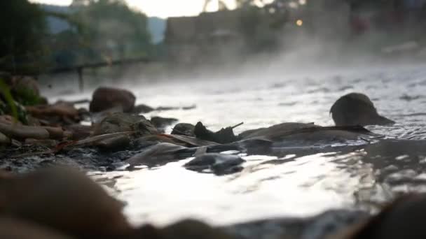早朝に蒸気で自然の岩のビーチをゆっくりと流れる新鮮な川の流れの水の眺め 田舎の美しい霧の川 — ストック動画