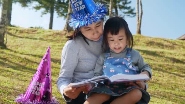Madre Asiática Leyendo Libro Hija Jardín Primavera Familia Pasar Tiempo — Vídeos de Stock