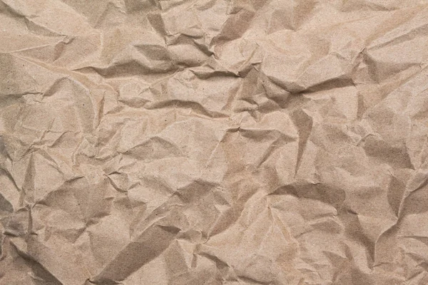 Close-up van bruin verfrommeld papier textuur achtergrond. — Stockfoto