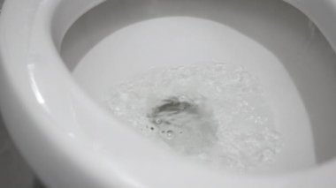 Close up of Water drained into the toilet bowl. Flushing Water in flush toilet.