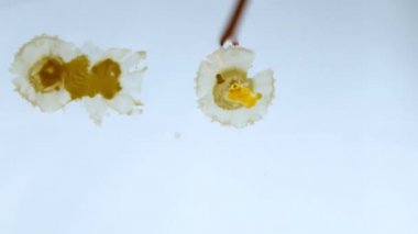 Candle drippings floating on the water surface. Creative background, Photos from the underwater corner.