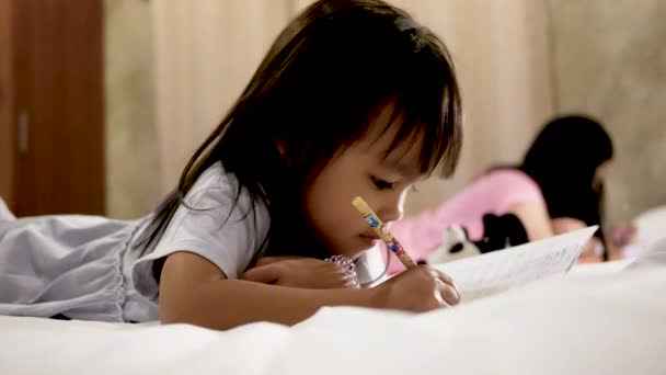 Nettes Kleines Kind Mädchen Macht Ihre Hausaufgaben Auf Dem Bett — Stockvideo
