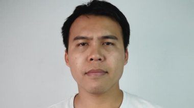 Suratını facepalm gibi kapatan canı sıkkın Asyalı adamın portresi. Gri arkaplandaki hayal kırıklığını ya da utancı ifade ediyor. Duygu ve ifade kavramları.