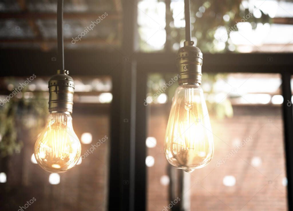 Decorative antique edison style light bulbs in the cafe. Lighting decor indoors concept.