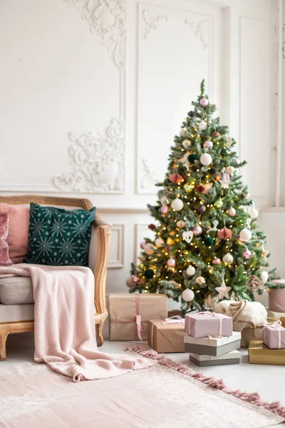 Un montón de cajas gif yacen junto al sofá y decoradas con guirnalda y juguetes árbol de Navidad. Enfoque selectivo — Foto de Stock