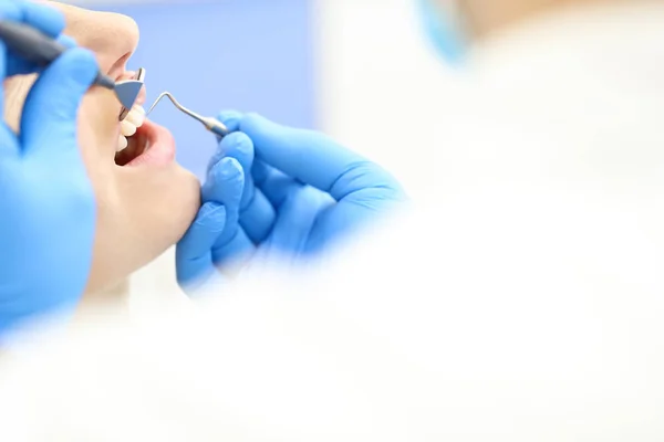 Closeup of face of female who undergo detntist checkup — Stock Photo, Image