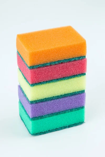 Multicolored sponges for washing dishes on white isolated background. Selective focus. — Stock Photo, Image