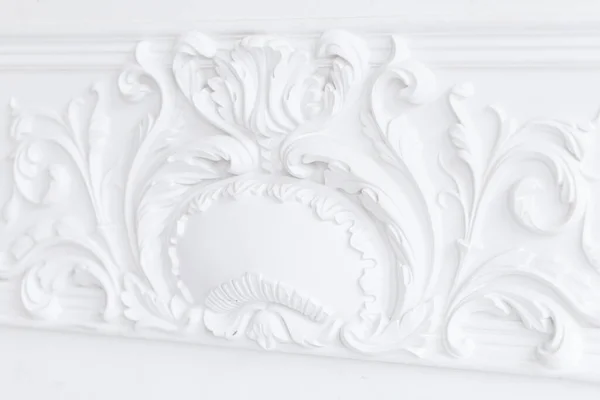 Beautiful ornate white decorative plaster moldings in studio. Royalty Free Stock Photos