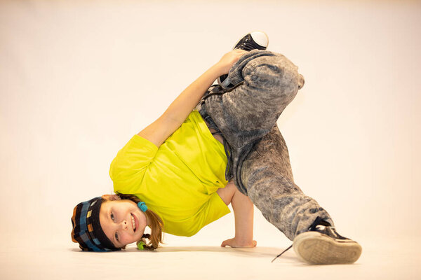 little girl in a unique dance pose, difficult acrobatic position, cheerful girl, exceptional child