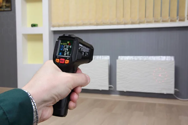 Infrared thermometer in hand