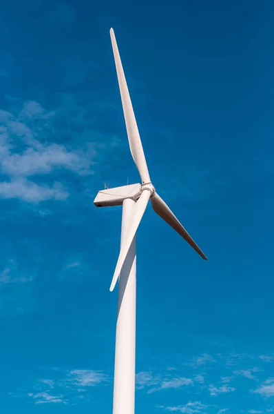 Electric wind turbine with clear blue sky