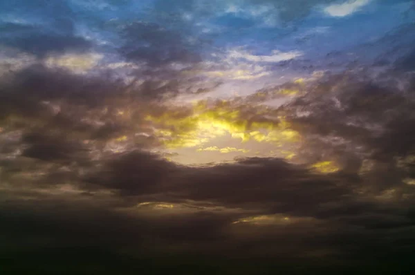 Dramatic sky at sunset with red, yellow, orange, gray and blue colors.