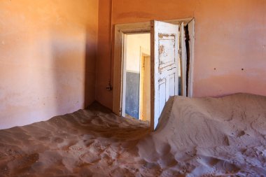 Terk edilmiş ve unutulmuş bina ve oda insanlar tarafından terk edilmiş ve işgal edilen kum fırtınası, Kolmanskop hayalet kasabası, Namib Çölü tarafından ele geçirilmiş.