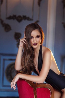 Stüdyoda poz veren güzel genç bir kadın.