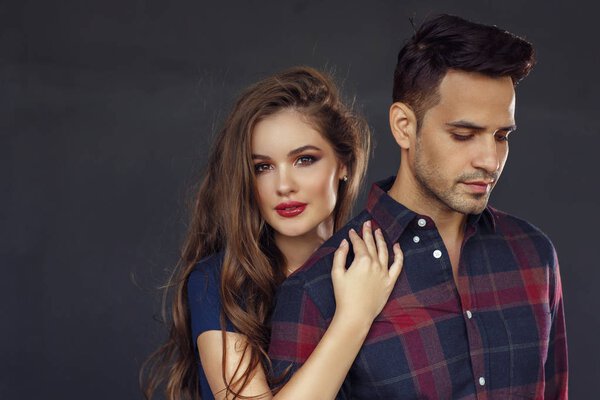 beautiful young couple posing in studio