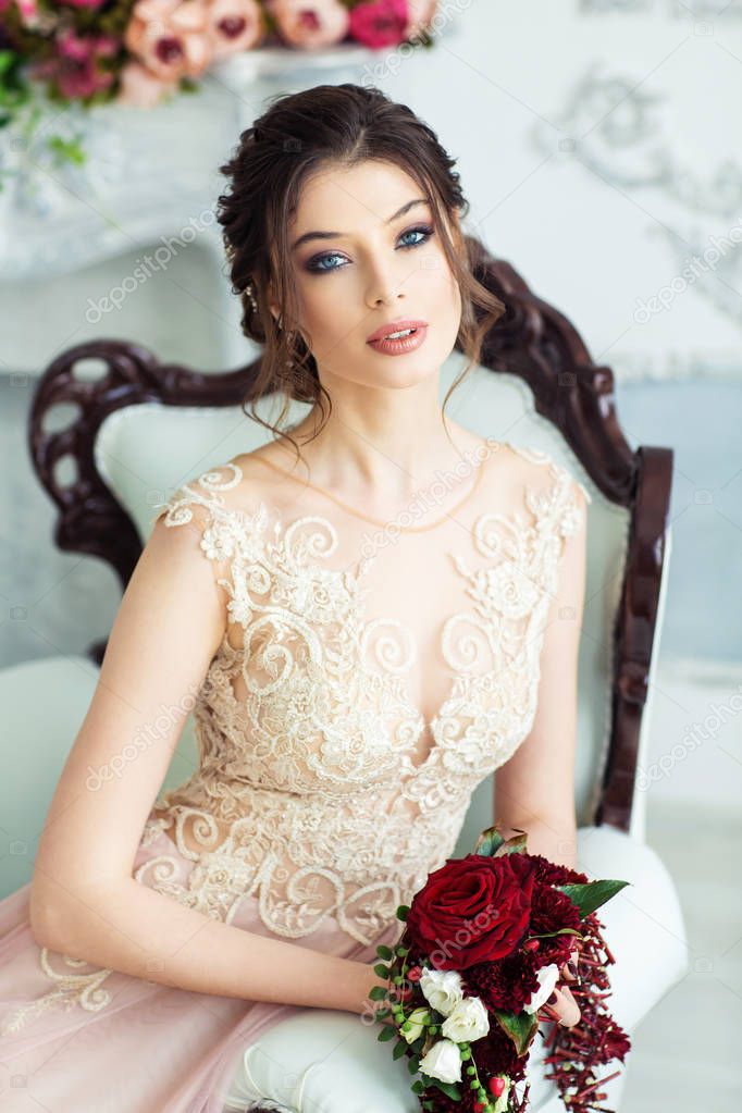 Gorgeous young woman in elegant wedding dress 