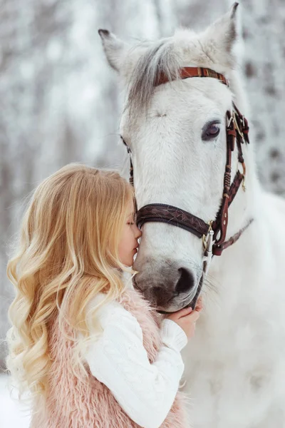 Little blonde girl with a white horse — Stock Photo, Image