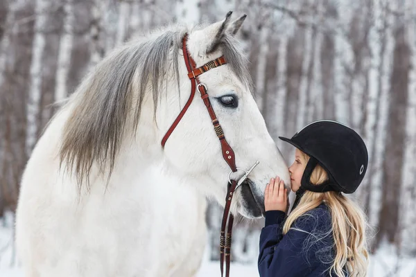 Little girl with a friesian horse, outdoor — Stock Photo, Image