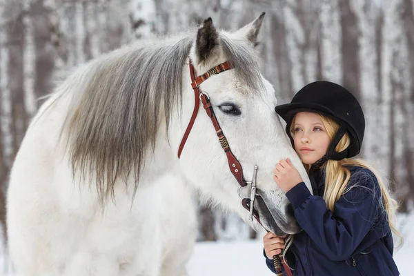 Little girl with a friesian horse, outdoor — Stock Photo, Image