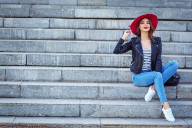 Beton merdiven açık üzerinde oturan şık kadın portresi tam uzunlukta
