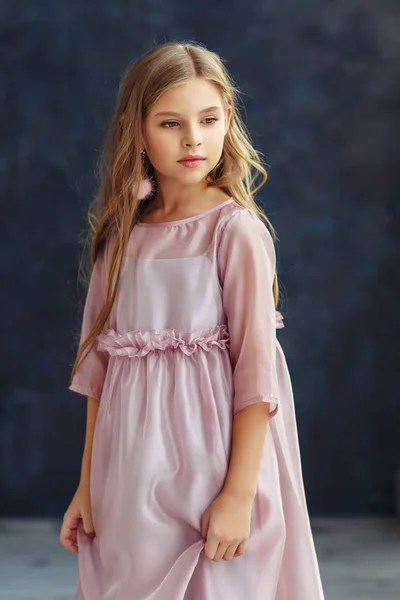 Cute little model in pink dress