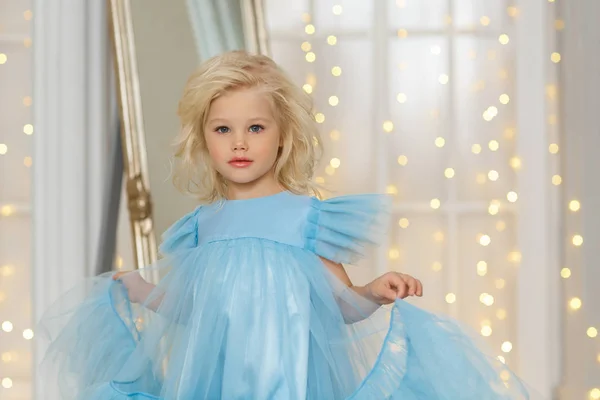 圣诞节穿蓝色连衣裙的小金发女郎 — 图库照片