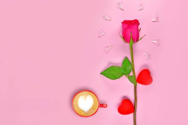 Pembe arka planda kalbi olan bir gül, mesaj için boşluğu kopyala. Bir fincan kahve. Yazı için yeri olan bahar çiçekleri. Çiçekler ve pembe arka planda beyaz bardak. Pembe arka planda taç yaprakları olan bir fincan kahve. Çiçekler ve kahve..