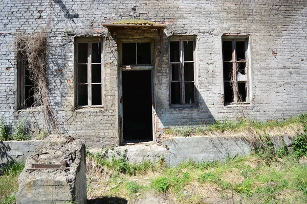 Destroyed industrial buildings. Abandoned brick buildings. Ruin and desolation in the industrial zone. Old abandoned houses.