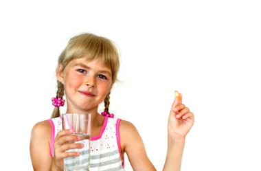  Little girl in a dress takes omega3. clipart