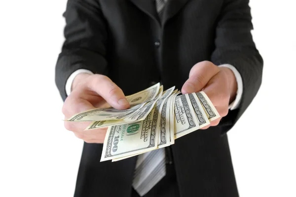 Homem de terno preto, segurando dinheiro nas mãos — Fotografia de Stock