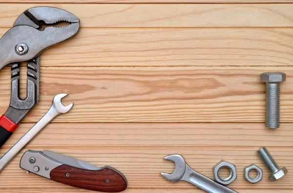 Manual, industrial repair tool on wooden table